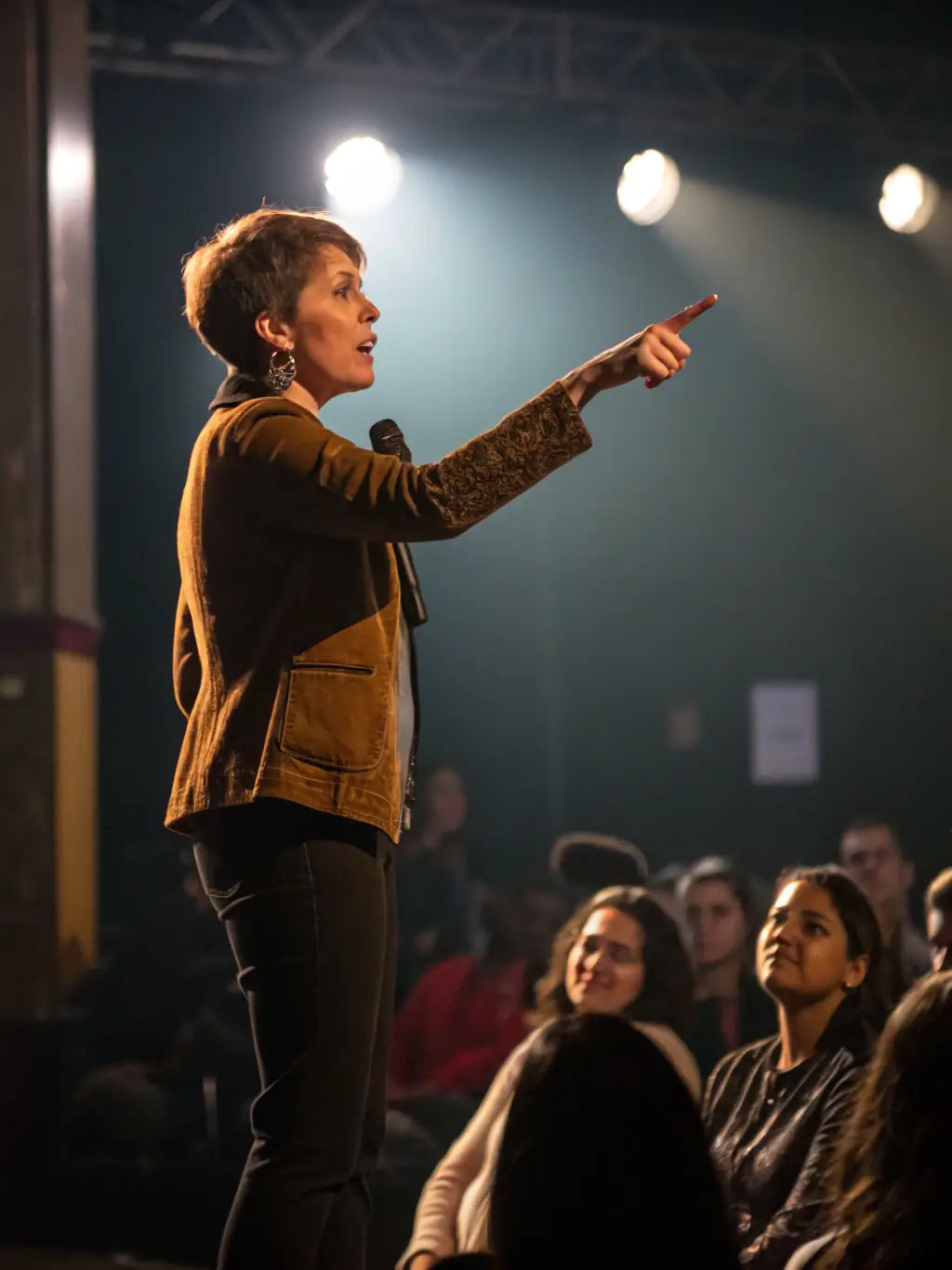 A motivational speaker addressing a room full of UK entrepreneurs at a business conference, inspiring them to achieve their goals.